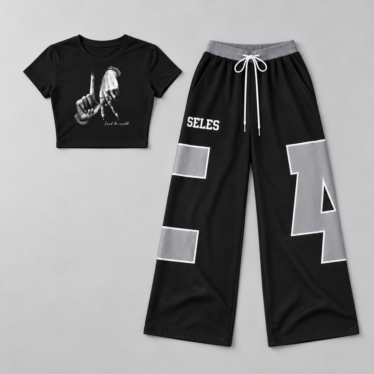 Flat lay of gray-black graphic crop top and wide-leg pants