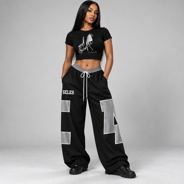 Women wearing gray-black urban graphic crop top and wide-leg pants set